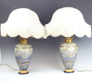 A pair of Doulton Lambeth oviform vases decorated with scrolling flowers, converted to table lamps 36cm 