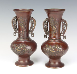 A pair of Japanese bronze twin handled vases with pierced handles, the bodies decorated birds amidst branches 23cm x 8.5cm 