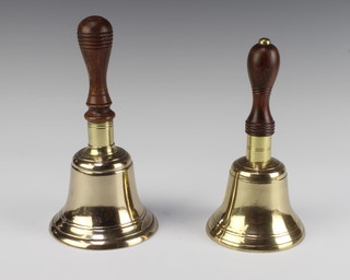 A brass hand bell with turned wooden handle 23cm x 12cm and 1 other 21cm x 10.5cm  