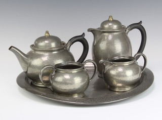 A Tudric English pewter for Liberty and Co 5 piece planised tea service comprising circular tray 35cm (some dents and slightly bent), teapot, hotwater jug, twin handled sugar bowl and cream jug, bases marked 01221  