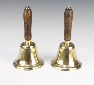 A pair of brass hand bells with turned wooden handles 23cm x 13cm diam. 