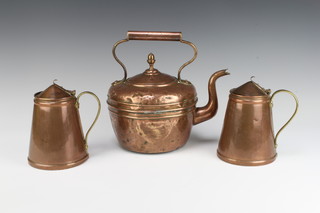 A pair of waisted copper and brass insulated jugs, the base with 3 hammer mark 14cm x 12cm together with a circular copper kettle with acorn finial 25cm x 22cm (some dents)