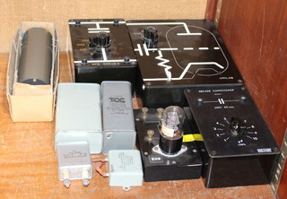 A mounted double valve, 2 capacitor boxes and a collection of capacitors 