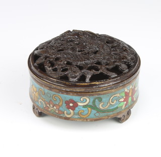 A circular Japanese cloisonne enamelled jar and cover with pierced lid, decorated a dragon, raised on 3 panel supports 4cm x 10cm diam. 