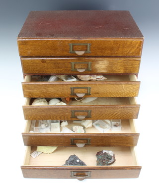 An oak collectors chest of 6 long drawers containing a collection of geological specimens 40cm x 39cm x 27cm 