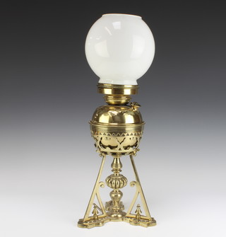 A Dresser style brass oil lamp with engraved reservoir raised on a triform base converted to electricity  