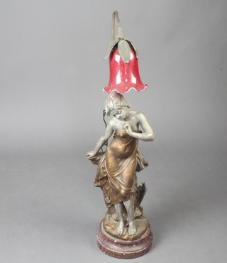 An Art Nouveau spelter figure in the form of a standing lady converted for use an electric table lamp, raised on a pink veined marble base 88cm h x 26cm diam. 