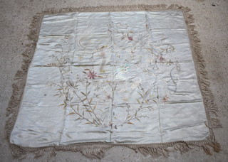 A white silk embroidered shawl decorated a dragon and with deep tassel fringe 149cm x 145cm