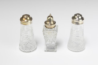 A silver mounted cut glass tapered sugar shaker, a pair of circular ditto 