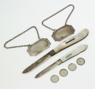 A pair of silver spirit labels 1971, 2 silver mother of pearl fruit knives and minor coins 