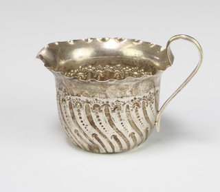 A Victorian repousse silver cream jug Sheffield 1887, 55 grams