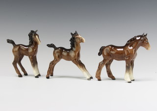 A Beswick figure of a shire foal (small) 1053 by Arthur Greddington 12.7cm, a ditto comical foal figure 728 by Arthur Greddington 12.7cm and a foal (large stretched) 836 by Arthur Greddington 12.7cm 