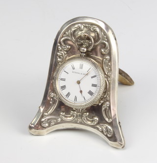 A Victorian repousse silver bell shaped pocket watch holder with a lady's silver cased fob watch Birmingham 1899, 9cm 
