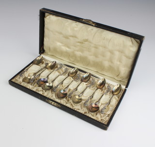 A cased set of 12, 800 standard, Rococo style teaspoons 132 grams, cased
