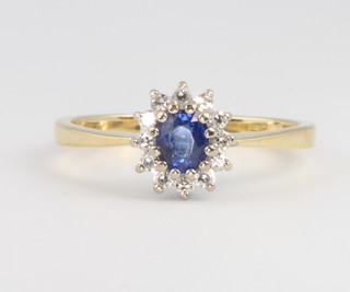 An 18ct yellow gold oval sapphire and diamond cluster ring size O 
