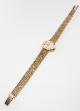 A lady's 9ct yellow gold Omega wristwatch on a bark finished bracelet 17 grams