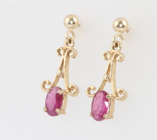 A pair of yellow gold ruby scroll ear studs 20mm 