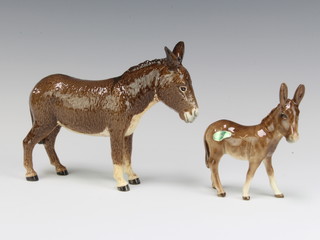 A Beswick figure donkey, second version, gloss 1364B by Mr Orwell 11.9cm and donkey foal 2110 grey brown gloss by Graham Tongue 11.9cm 