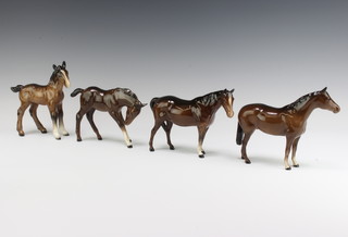 A Beswick figure mare facing right head up 1991 14cm, ditto mare facing left 1992 brown gloss by Arthur Greddington 14cm, ditto foal large head down 947 brown gloss by Arthur Greddington 11.9cm and another shire foal large 951 brown gloss by Arthur Greddington 15.9cm 