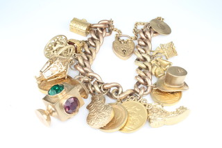 A 9ct yellow gold charm bracelet including a sovereign 1871, a sovereign 1927, a half sovereign 1910, a half sovereign 1911, 2 charms with hardstone mounts, gross excluding coinage 90 grams, total including coinage 115 grams 