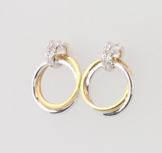 A pair of 18ct 2 colour gold diamond set earrings 