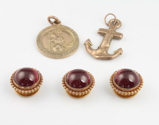 Three yellow gold cabochon cut dress studs and two gold charms 