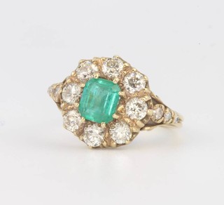 An 18ct yellow gold emerald and diamond cluster ring the centre stone approx 1.2ct surrounded by brilliant cut diamonds 1.35ct, size N 