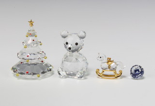 A Swarovski Crystal Christmas tree 8cm, ditto teddy bear 7cm, a rocking horse 4.5cm and a paperweight 1.5cm, boxed