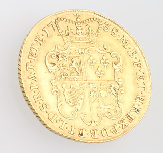 A George II shield back two Guinea with second young laureate head left, dated 1738, 16.7 grams 