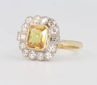 An 18ct yellow gold, yellow sapphire and diamond cluster ring, the centre stone approx. 1.5ct surrounded by brilliant and baguette cut diamonds approx. 0.85ct size P 1/2