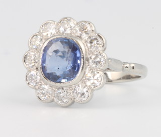 An 18ct white gold sapphire and diamond cluster ring, the centre stone approx. 2ct surrounded by 12 brilliant cut diamonds approx. 1ct size O 