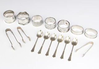 A set of Edwardian silver teaspoons and sugar tongs Sheffield 1907 and 7 silver napkin rings 250 grams 