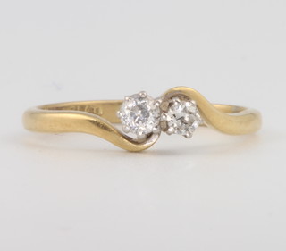 An 18ct yellow gold 2 stone diamond crossover ring size N 2.8 grams 