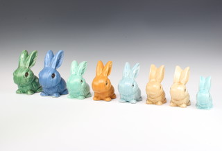 A beige Sylvac rabbit 990 12cm, a blue ditto 1067 10cm, a ditto beige 990 12cm, a green ditto 1026 16cm, a blue ditto 1026 16cm, two similar bunnies 