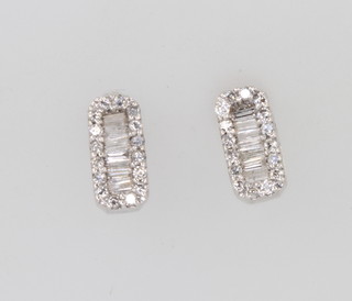 A pair of 18ct white gold baguette and brilliant cut diamond ear studs, 2.2 grams