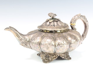 A George IV silver melon shaped teapot with floral finial, the repousse body decorated with flowers raised on scroll feet, London 1828, gross 764 grams 