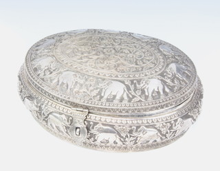 An early 20th Century Indian repousse silver oval casket profusely decorated with elephants and flowers having a lockable clasp 30cm, 1595 grams 