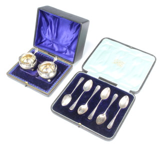 A pair of Edwardian silver boxed salts and spoons Birmingham 1906 and a set of 6 cased silver rat tail coffee spoons Sheffield 1908, 138 grams 