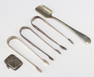 A silver marrow scoop Sheffield 1924, three pairs of sugar tongs and a vesta 165 grams 