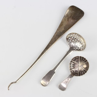 A George IV silver sifter spoon, London 1822, a caddy spoon, boot hook and shoe horn 93 grams