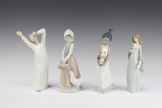 A Lladro figure of a young girl holding a cat 5603 21cm, ditto of a lady holding a scarf 20cm, ditto yawning boy 22cm and a Nao figure of a girl with chicken and chicks 20cm 
