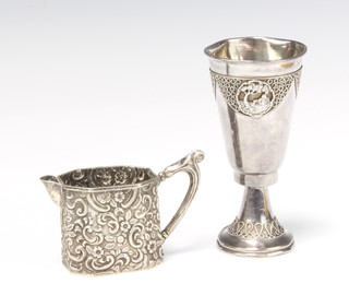 A Victorian repousse silver octagonal cream jug Birmingham 1897 and a Continental silver Kiddush cup 102 grams 