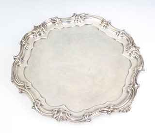 A Georgian design silver salver with scroll rim and scroll feet, 900gms 32cm diam