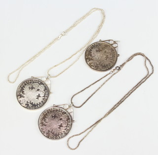 Three Marie Therese coins mounted as pendants on silver chains 