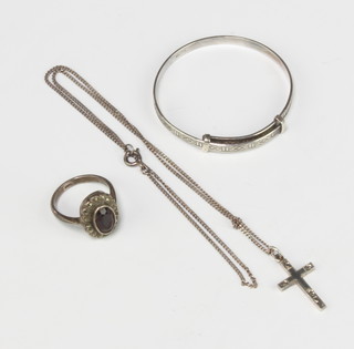 A childs silver bangle, ditto ring, cross pendant and chain 
