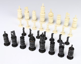 A carved and stained bone chess set, the King 13cm 