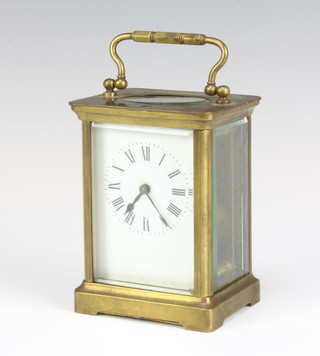 A French 8 day carriage timepiece with enamelled dial and Roman numerals contained in a gilt metal case 11cm x 8cm x 6.5cm, complete with key 