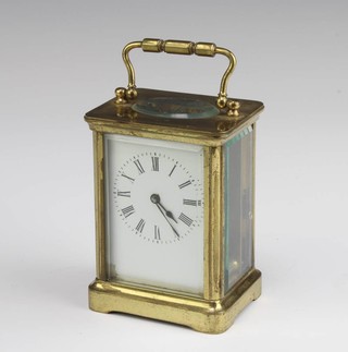 A French 8 day carriage timepiece with enamelled dial and Roman numerals, contained in a gilt metal case 11cm x 7cm x 6cm, complete with key 