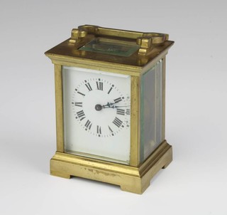 A French 8 day carriage clock with enamelled dial and Roman numerals contained in a gilt metal case 10cm x 7.5cm x 7cm, complete with key 