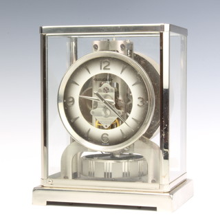 Jaeger LeCoultre, possibly a Limited Edition Jubilee Atmos clock, numbered 428411, contained in a white metal and glass case, the base of the clock marked Jaeger LeCoultre metal caliber 528-6 Swiss  